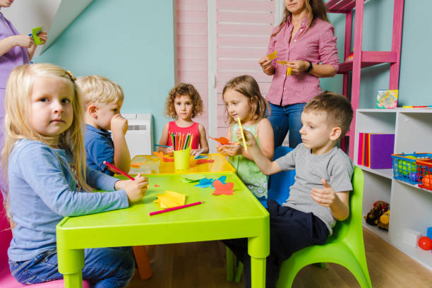 istock Full Length Of Friends Sitting On Table 1352041067