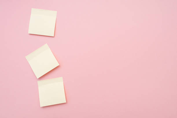 istock Three blank memo stickers on pink surface. Top view, space for text. 1352041204