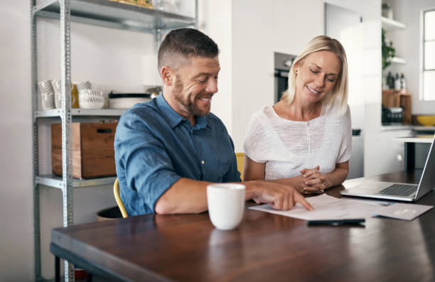 istock Shot of a couple reviewing bills while using their laptop 1352041422