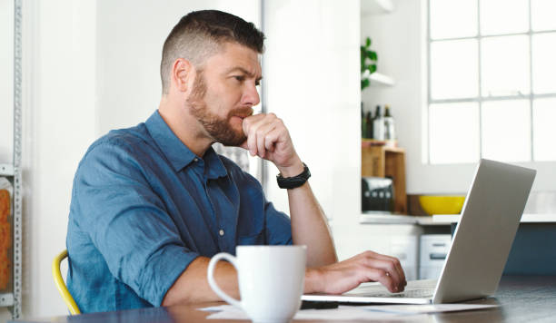 istock Shot of a businessman working from home using his laptop 1352041445
