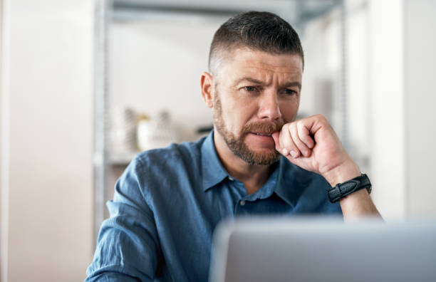 istock Shot of a businessman working from home using his laptop 1352041447