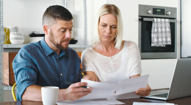 istock Shot of a couple reviewing bills while using their laptop 1352041474