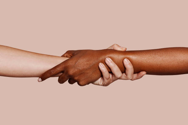 istock Close up multiracial black and white hands holding each other 1352041541