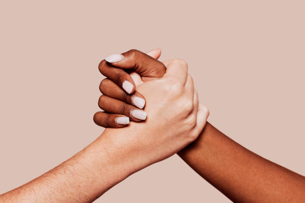 istock Close up multiracial black and white hands holding each other 1352041675
