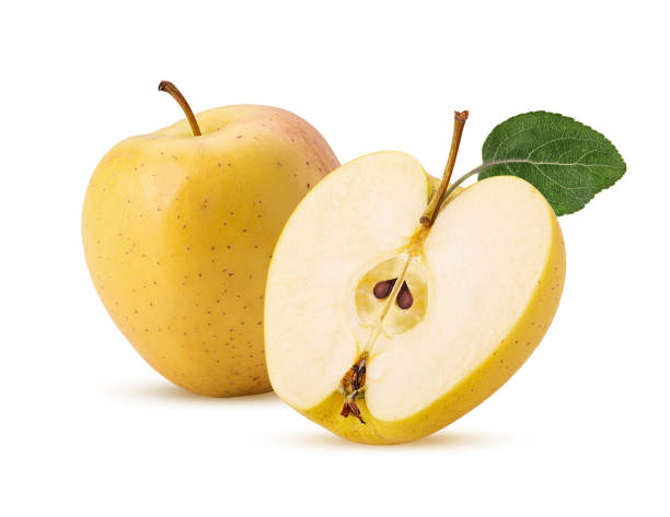 istock Golden apple delicious one cut in half with green leaf 1352041896