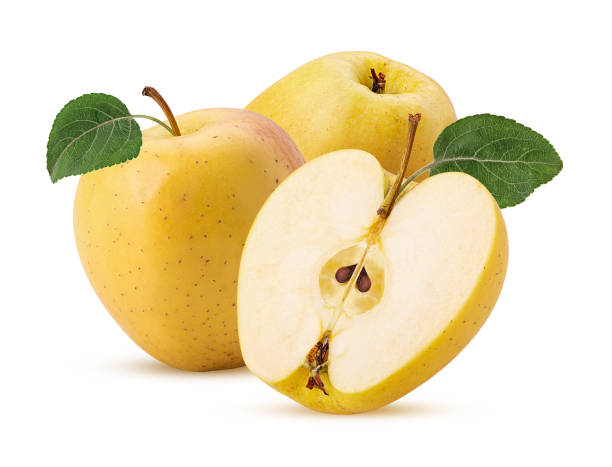 istock Two glden apple delicious one cut in half with green leaf 1352042478