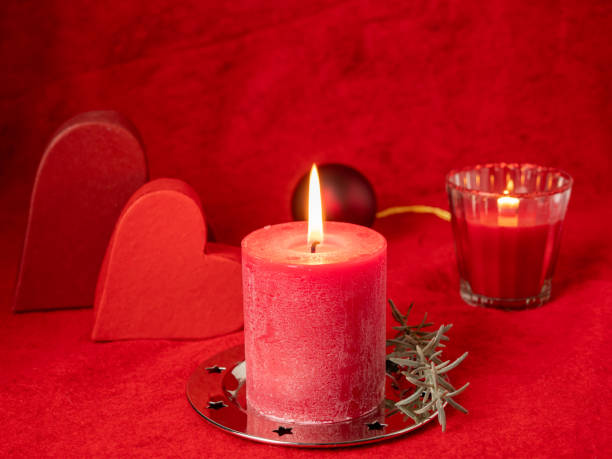 istock Red Christmas candle and Christmas decorations on a red background 1352044811