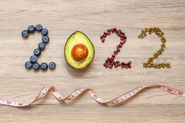 istock 2022 Happy New Year with fruit and vegetable; Blueberries, Avocado and Bean on table. Goals, Healthy, Motivation, Resolution, Time to New Start, dieting and world food day concept 1352044959