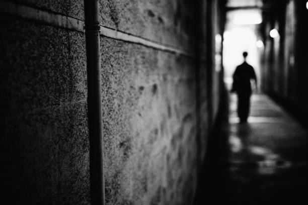 istock Image of a man walking in a tunnel, Monochrome 1352048167