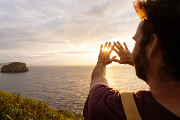 istock Panoramic view of unrecognizable man at sunset in a cliff. 1352049255