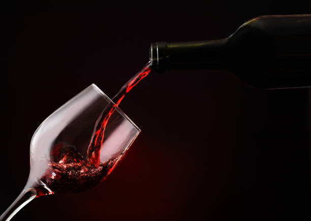 istock pouring wine from a bottle into a goblet 1352055300