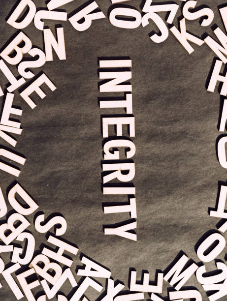 istock Integrity Word In Wooden Cube Alphabet Letters Top View On A rustic paper Background. 1352055370