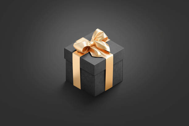 istock Blank black gift box with gold ribbon mockup, dark background 1352057846