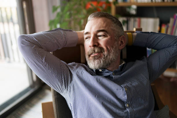 istock nice Joyful mature man at home appartement with grey beard 1352064110