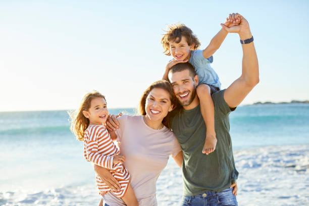 istock Happy parents with children at beach 1352066773