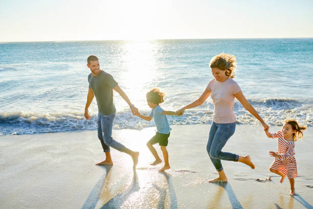 istock Family enjoying at beach during vacation 1352066781