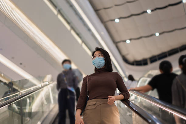 istock Asian beauty going downstairs by escalator 1352067029