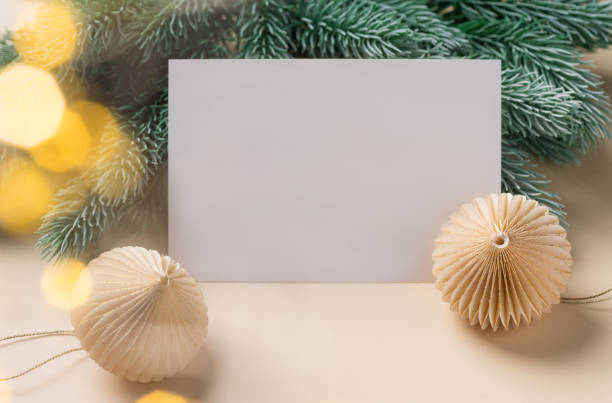 istock Paper blank, christmas decorations, fir branches and blurred lights 1352067198