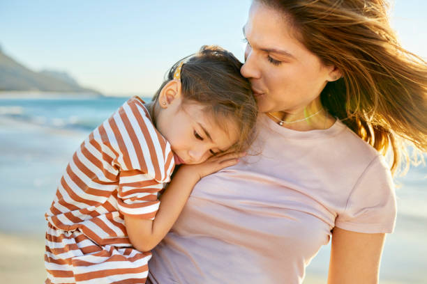 istock Mother and daughter at beach during vacation 1352067793