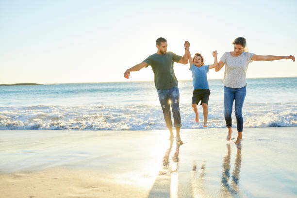 istock Family enjoying at beach during vacation 1352067817
