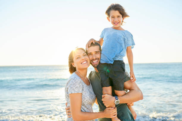 istock Happy parents with son at beach 1352067830