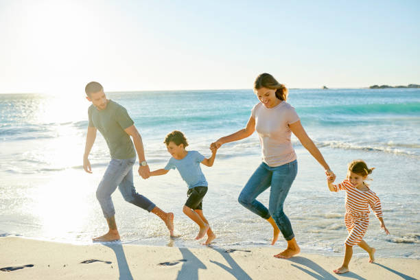 istock Family enjoying at beach during summer vacation 1352068595