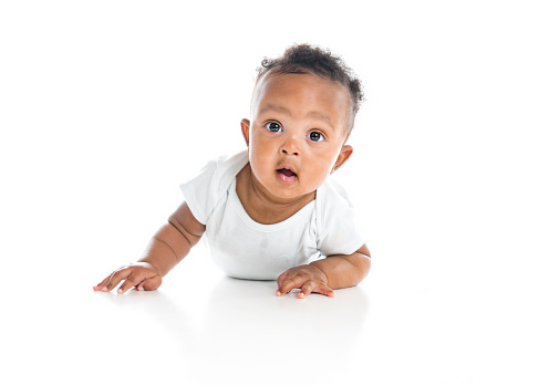 A five month old African American baby boy on studio white
