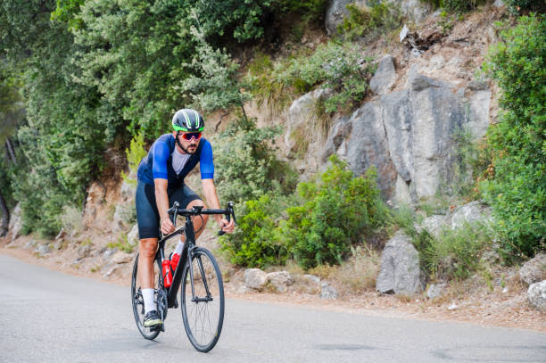 istock Cyclist on a mountain road with copy space 1352072537