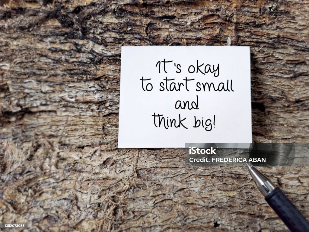 Inspirational and Motivational Quote 'It's okay to start small and think big' text background. Stock photo. Inspirational Quote Stock Photo