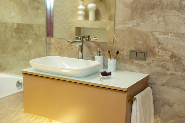 istock Modern bathroom in beige tones with marble tiles and white sink. Interior Design. Soft selective focus, art noise 1352073863
