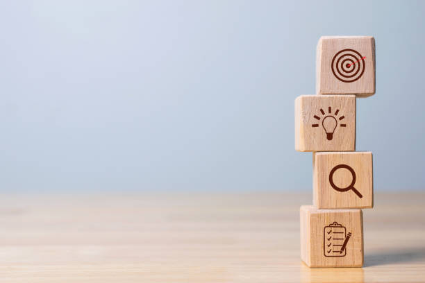 istock Wood cube block stacking with icon. business strategy and action plan Concept. 1352075133