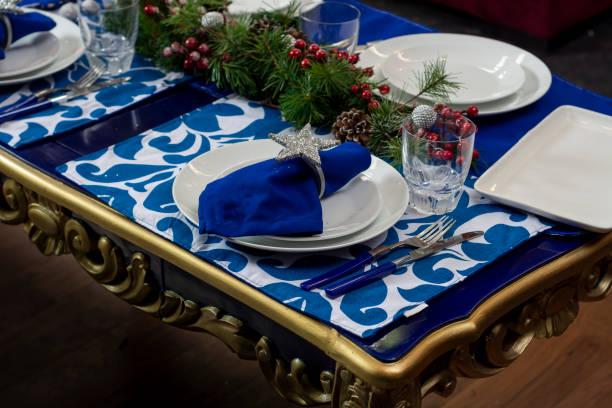 istock table with blue Christmas decoration, with crockery and glassware for Christmas dinner 1352076119