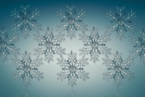 Gray snowflake photographed on light blue background