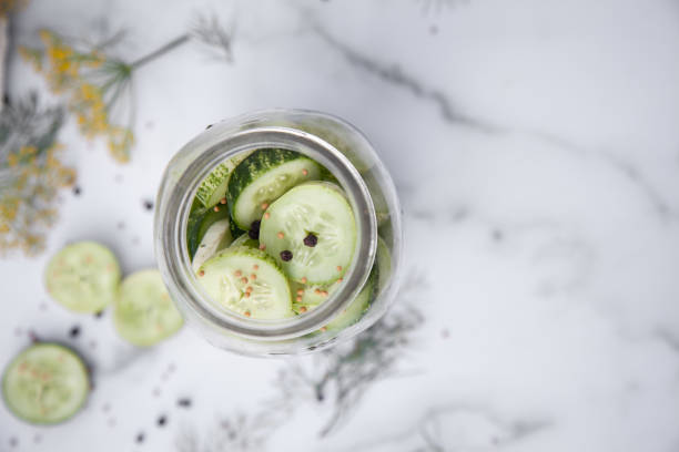 istock Homemade Pickles and Dill on a Marble Countertop 1352076999
