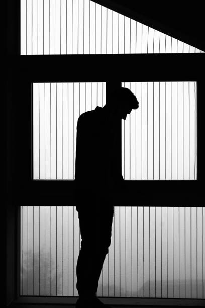 istock View of young man talking on the phone, in silhouette 1352078224