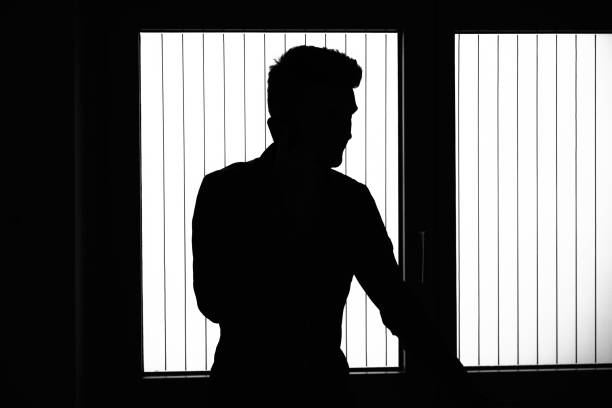 istock View of young man talking on the phone, in silhouette 1352078253