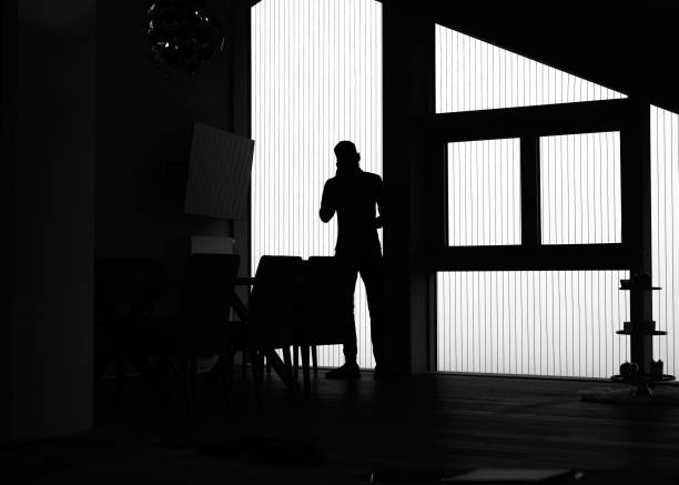 istock View of young man talking on the phone, in silhouette 1352078263