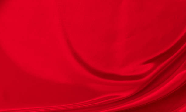 istock Black red satin dark fabric texture luxurious shiny that is abstract silk cloth background with patterns soft waves blur beautiful. 1352078381