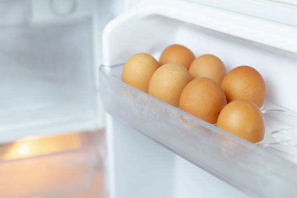 istock Chicken eggs on the fridge door 1352078908