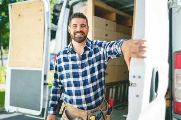istock Portrait of an electrician happy worker at work 1352079919