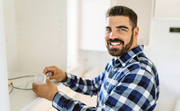 istock Portrait of an electrician happy worker at work 1352080039