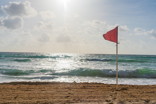 Red Flag on Beach Marking unsafe Water for Swimming