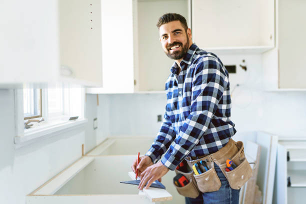 istock Concentrated young man work with white cabinet in the kitchen 1352080108