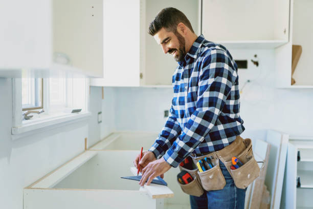 istock Concentrated young man work with white cabinet in the kitchen 1352080109