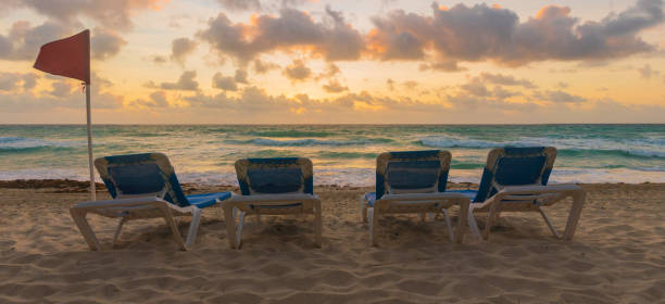Group of Tanning Chairs on the Beach at Sunrise in Cancun, Mexico