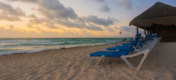 Group of Tanning Chairs on the Beach at Sunrise in Cancun, Mexico