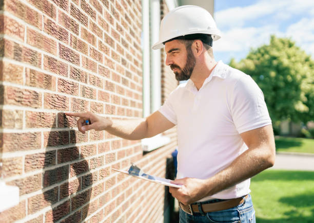 istock man with a white hard hat holding a clipboard, inspect house 1352080485