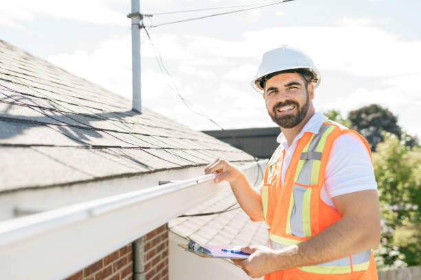 man in a hard hat, holding a clipboard, standing on the steps of an old rundown house. A man in a hard hat, holding a clipboard, standing on the steps of an old rundown house. rooftop stock pictures, royalty-free photos & images