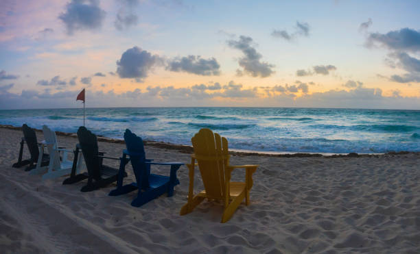 istock Group of Beach Chairs on the Beach at Sunrise 1352080842