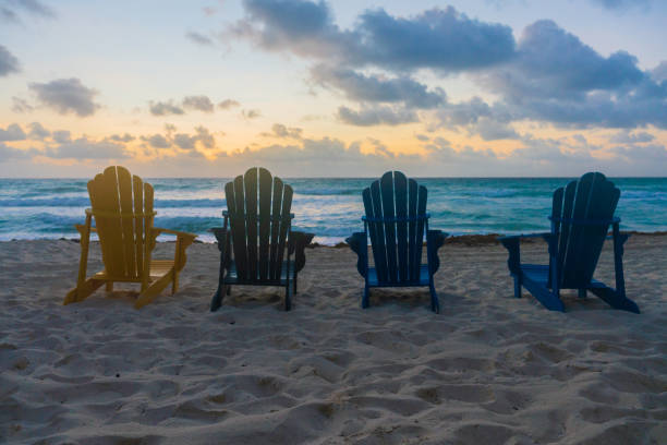 istock Group of Beach Chairs on the Beach at Sunrise 1352080892